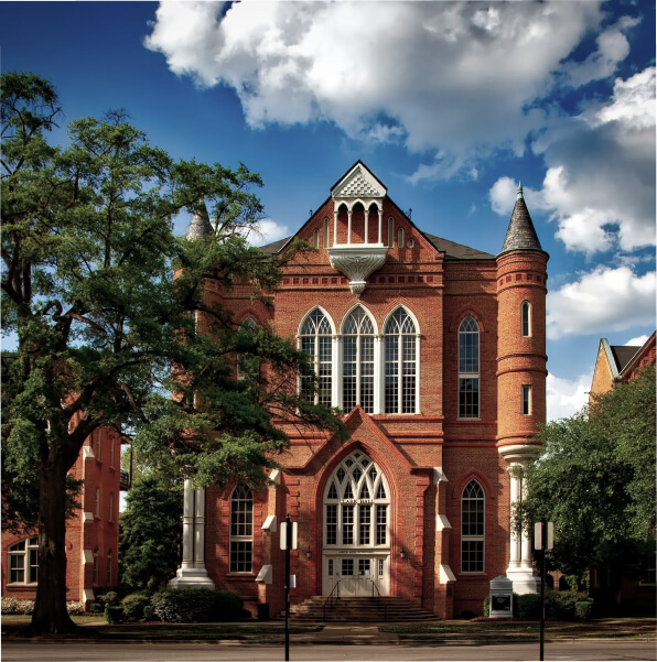 red brick building, with huge white windows, university